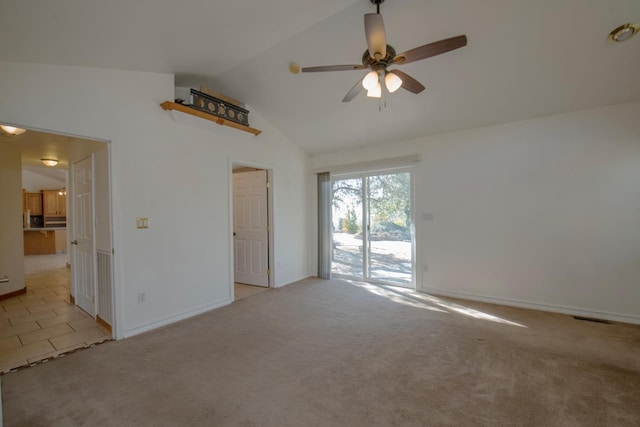 carpeted empty room with ceiling fan and lofted ceiling