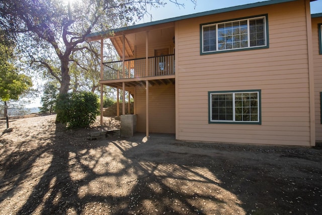 rear view of property featuring a balcony