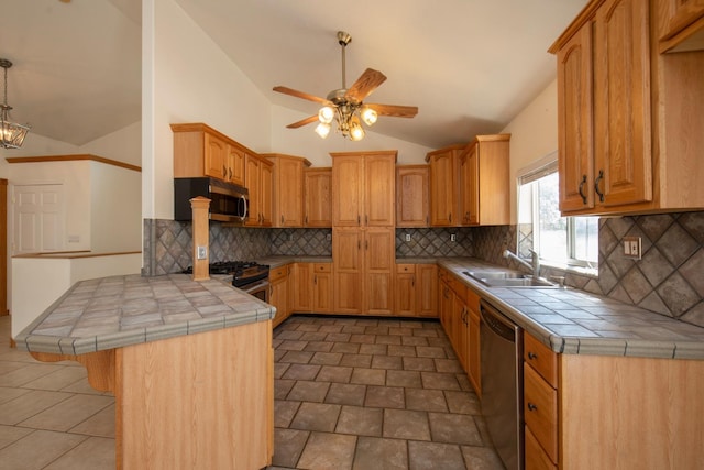 kitchen featuring sink, kitchen peninsula, tile counters, and stainless steel appliances