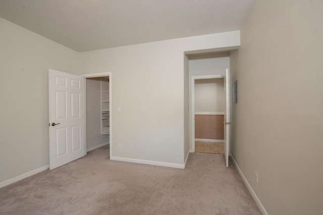 unfurnished bedroom featuring light carpet