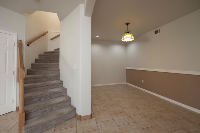 stairway featuring tile patterned flooring