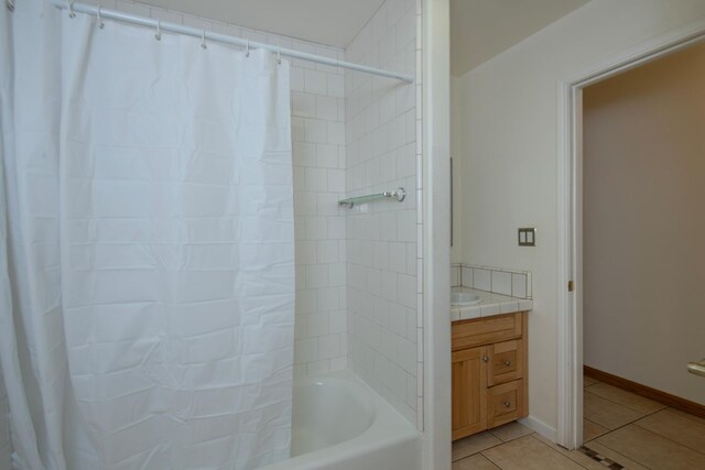 bathroom featuring vanity, shower / bathtub combination with curtain, and tile patterned floors