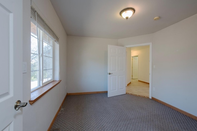 unfurnished room featuring plenty of natural light and light colored carpet