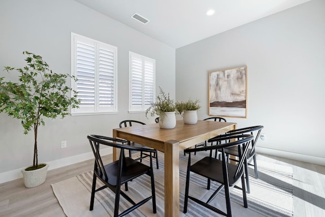 dining area with light hardwood / wood-style floors