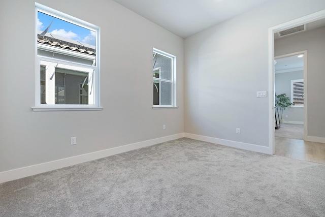 empty room featuring light carpet