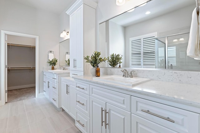 bathroom featuring vanity, walk in shower, and tile patterned flooring