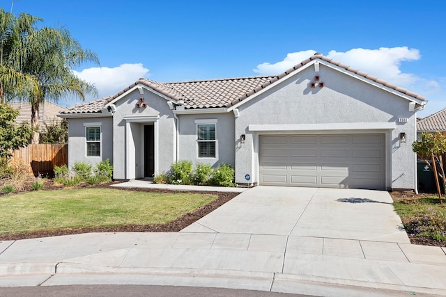 mediterranean / spanish-style house with a front yard and a garage