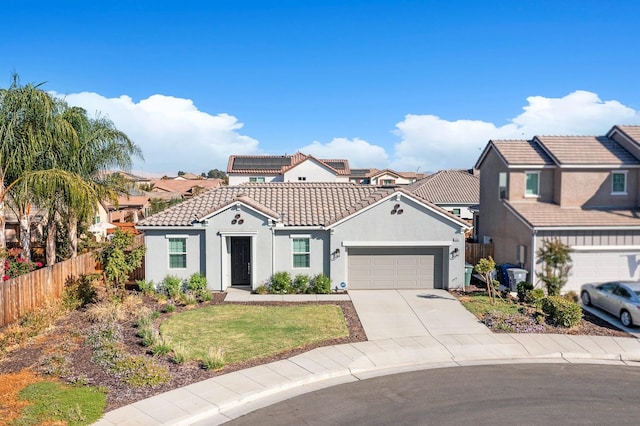 view of front of property featuring a front lawn and a garage