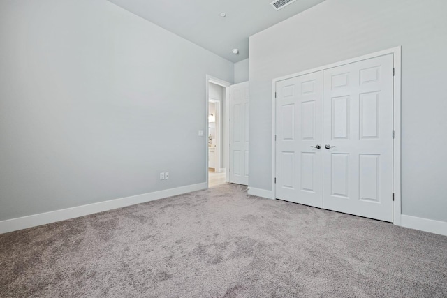 unfurnished bedroom featuring a closet and carpet flooring