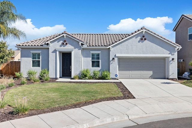 view of front of house featuring a garage and a front lawn