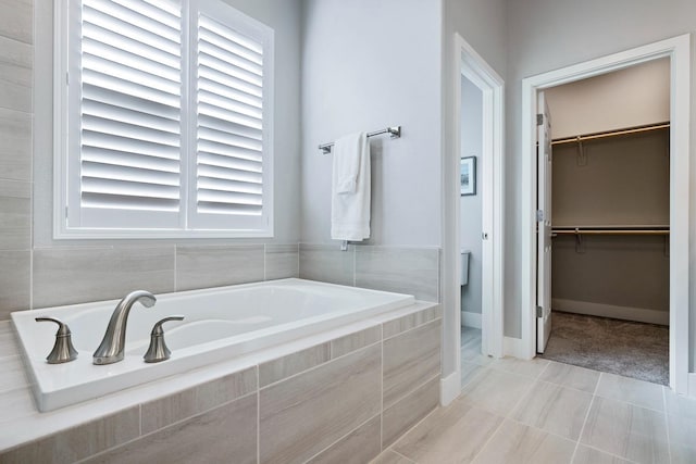 bathroom featuring tiled tub