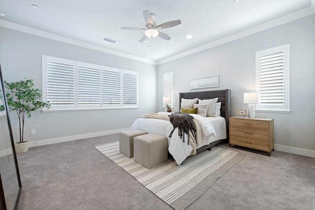 carpeted bedroom featuring ceiling fan, ornamental molding, and multiple windows