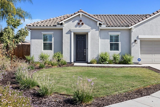 view of front of property with a front yard and a garage