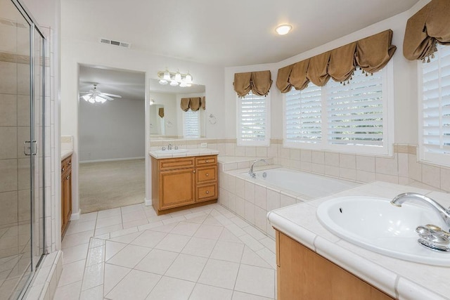 bathroom featuring ceiling fan, tile patterned floors, plus walk in shower, and vanity