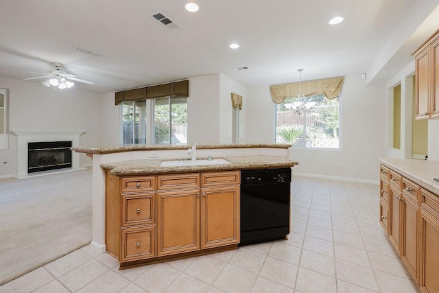 kitchen with sink, light tile patterned floors, hanging light fixtures, and black dishwasher