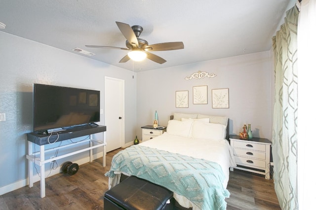 bedroom with dark wood-type flooring and ceiling fan