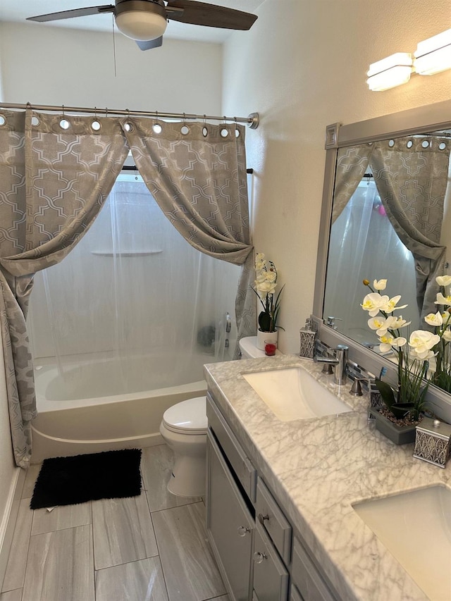 full bathroom featuring vanity, shower / bath combo with shower curtain, and toilet