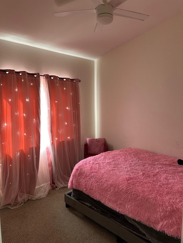 bedroom with ceiling fan and carpet floors