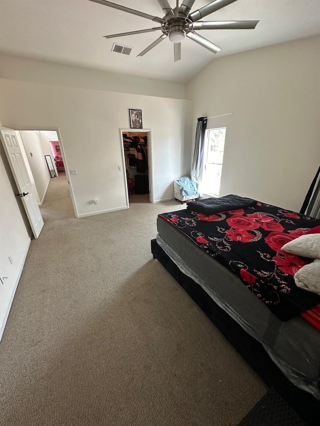 bedroom featuring vaulted ceiling, light colored carpet, and ceiling fan