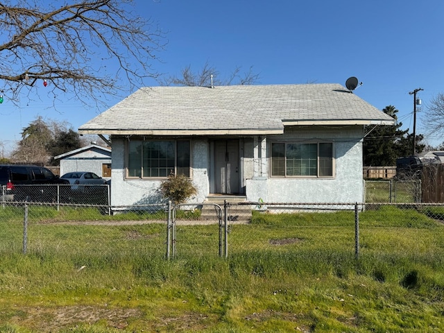 bungalow-style home with a front yard