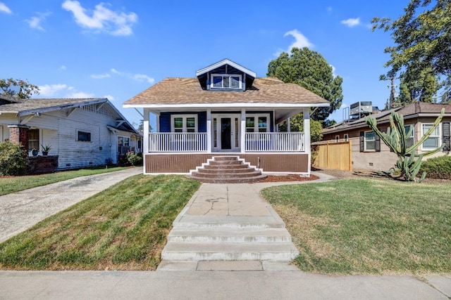 bungalow-style house with covered porch and a front yard