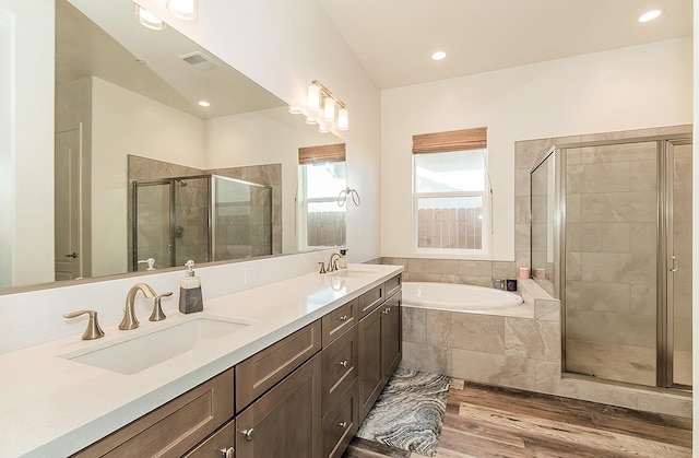 bathroom with vanity, plus walk in shower, and wood-type flooring