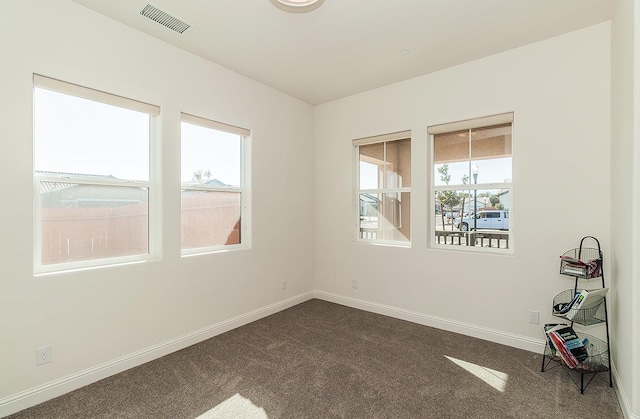 empty room featuring dark carpet