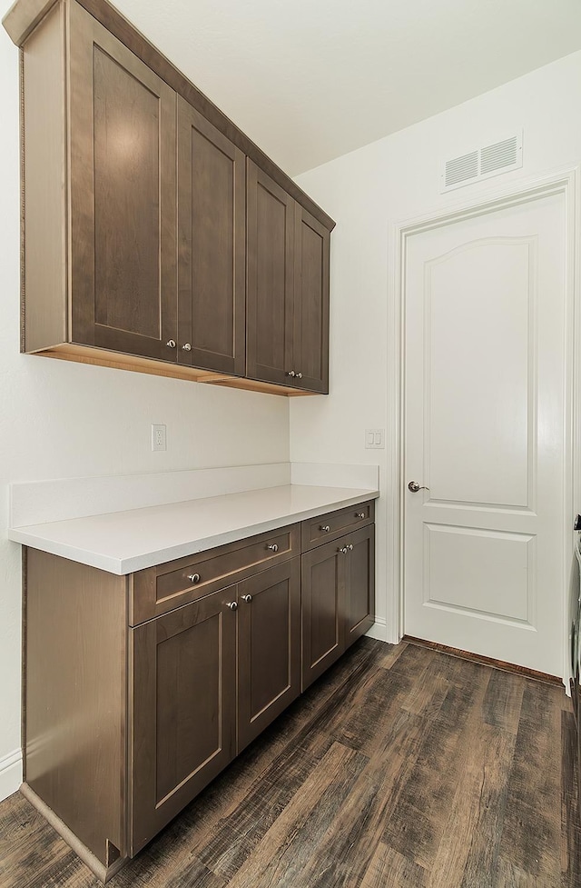 interior space with dark brown cabinetry and dark hardwood / wood-style floors