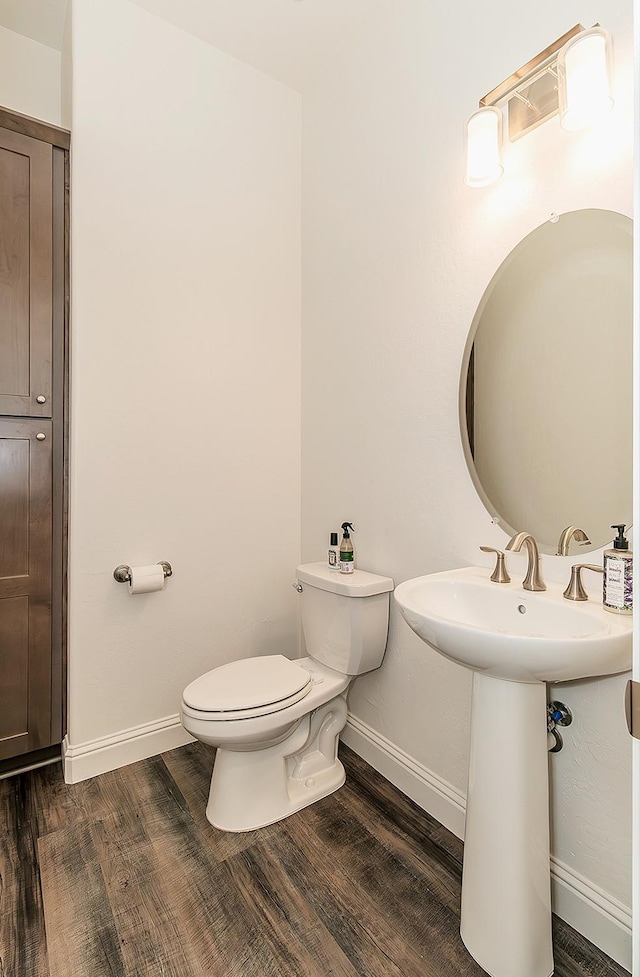 bathroom featuring sink, hardwood / wood-style flooring, and toilet