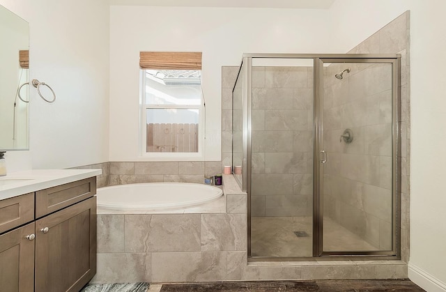 bathroom featuring vanity and shower with separate bathtub