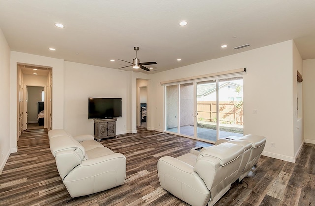 living room with dark wood-type flooring and ceiling fan