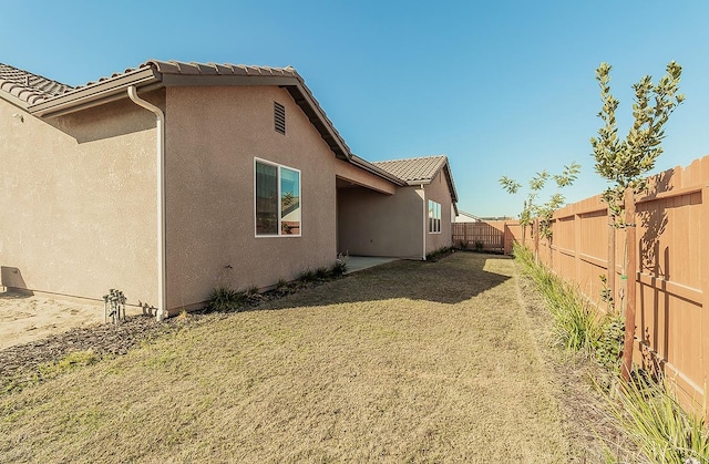 view of side of property with a yard