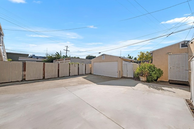 view of patio with an outbuilding and a garage