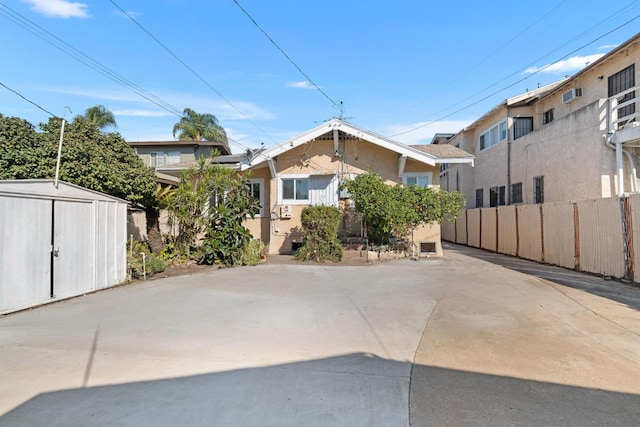 view of front of house with a storage shed