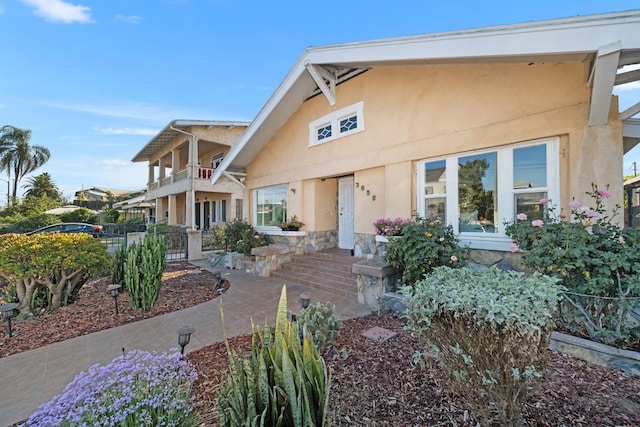 rear view of property featuring a balcony