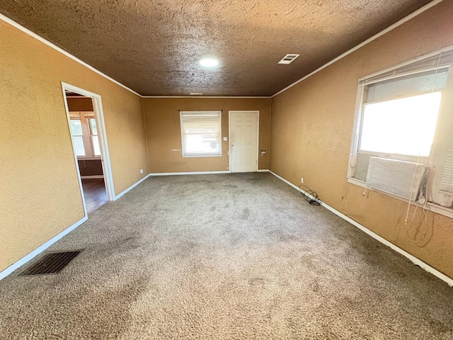 unfurnished room featuring ornamental molding, carpet floors, cooling unit, and a textured ceiling