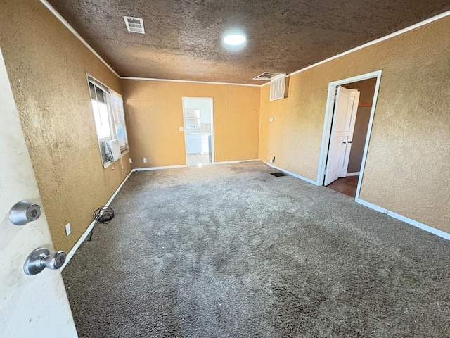 carpeted spare room with crown molding and a textured ceiling