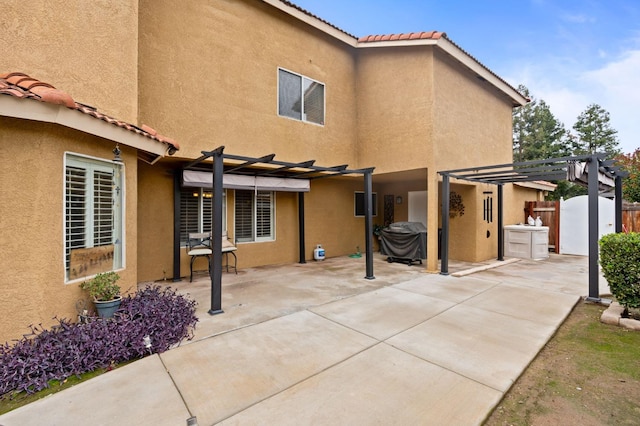 view of property exterior with a pergola and a patio