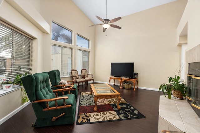 living room with wood-type flooring, high vaulted ceiling, and a healthy amount of sunlight