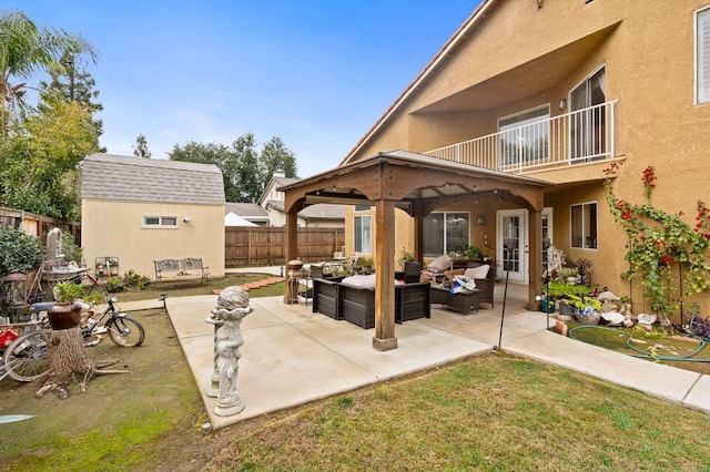 view of patio with an outdoor living space, a balcony, and an outdoor structure