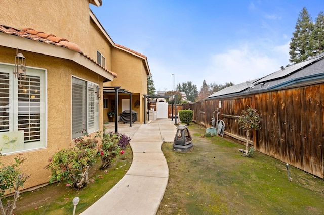 view of yard with a pergola and a patio