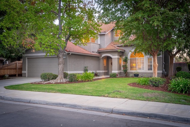 view of front of property featuring a garage and a front lawn