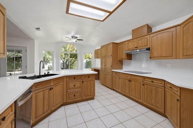 kitchen featuring stainless steel dishwasher, black electric cooktop, a wealth of natural light, and vaulted ceiling