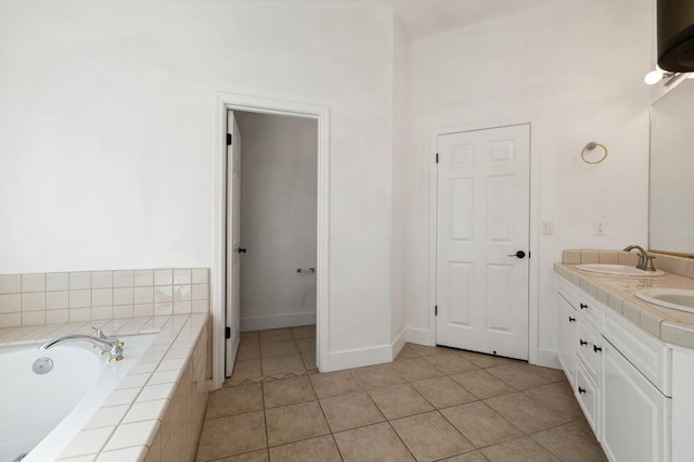 bathroom with vanity, tiled tub, and tile patterned floors