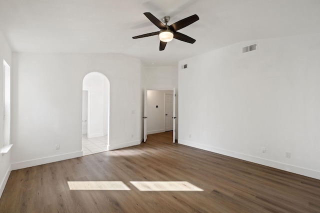 empty room with vaulted ceiling, light hardwood / wood-style flooring, and ceiling fan