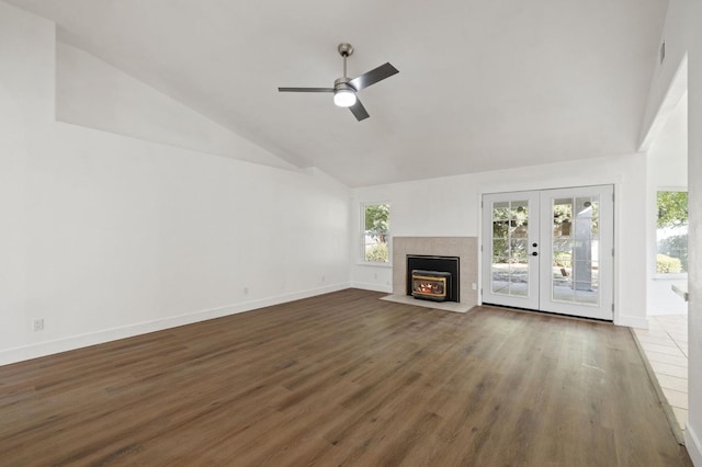 unfurnished living room featuring dark wood-type flooring, ceiling fan, high vaulted ceiling, and french doors