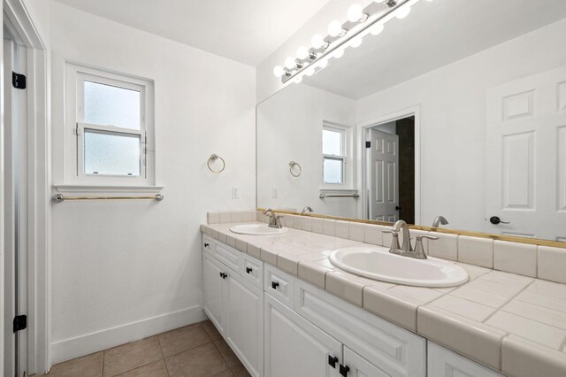 bathroom featuring vanity, tile patterned floors, and plenty of natural light