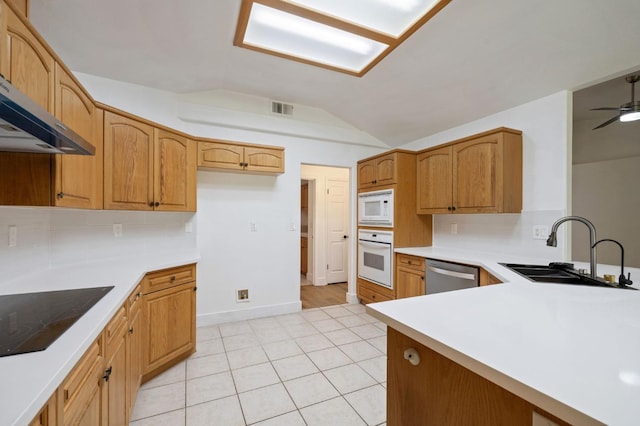 kitchen featuring tasteful backsplash, vaulted ceiling, sink, ventilation hood, and white appliances