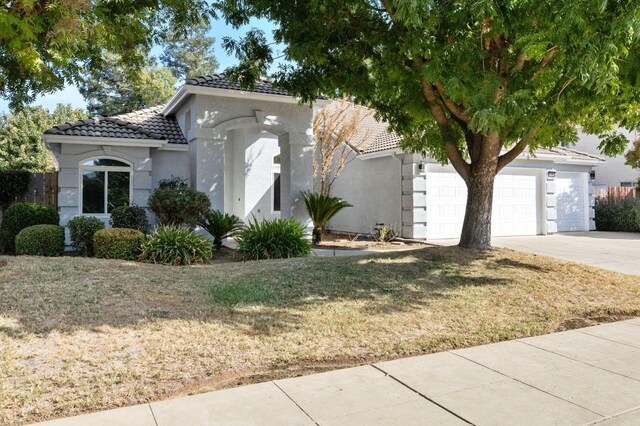 view of front of house with a front yard and a garage