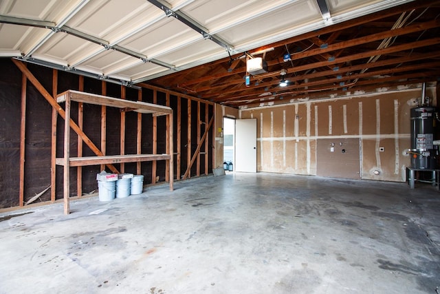 garage featuring a garage door opener and water heater